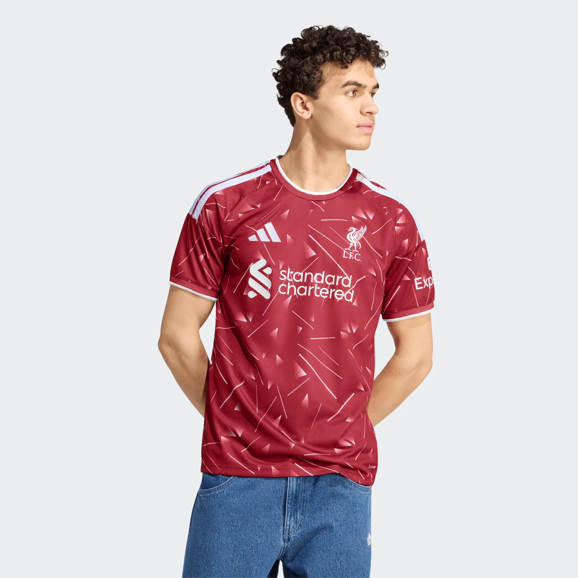 Person wearing a maroon sports jersey with branding on a light gray background