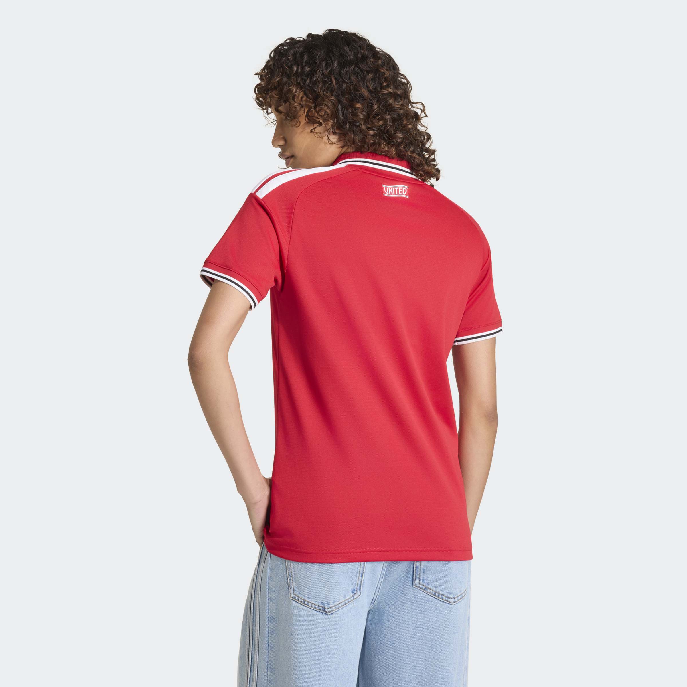 manchester united 2026/27 home shirt, red and white, back view on background
